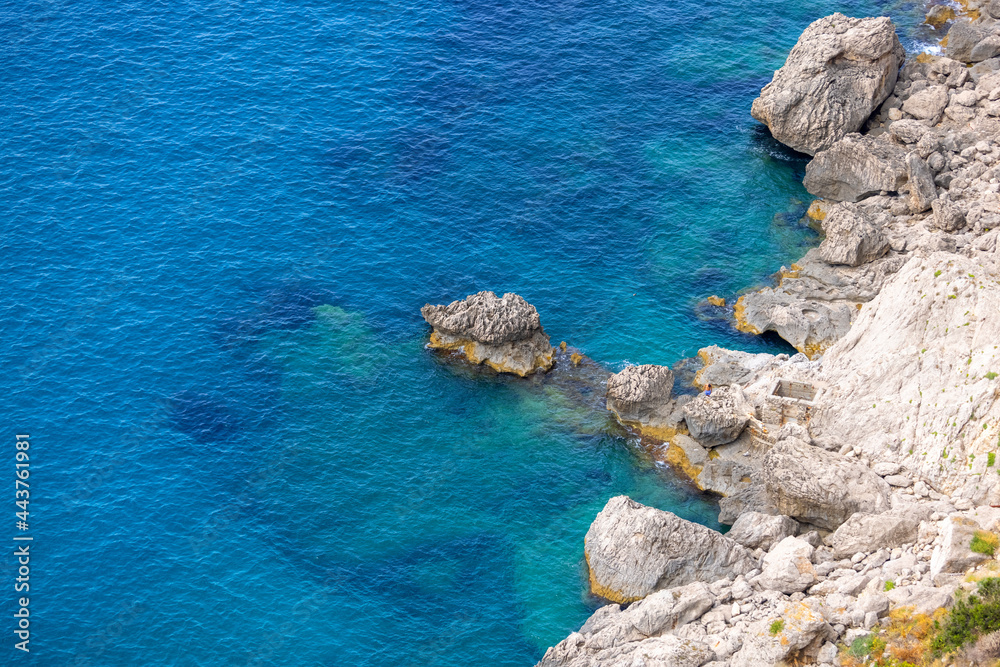 Rocky shoreline on the Tyrrhenian Sea nearby Marina Piccola, Capri Island, Italy