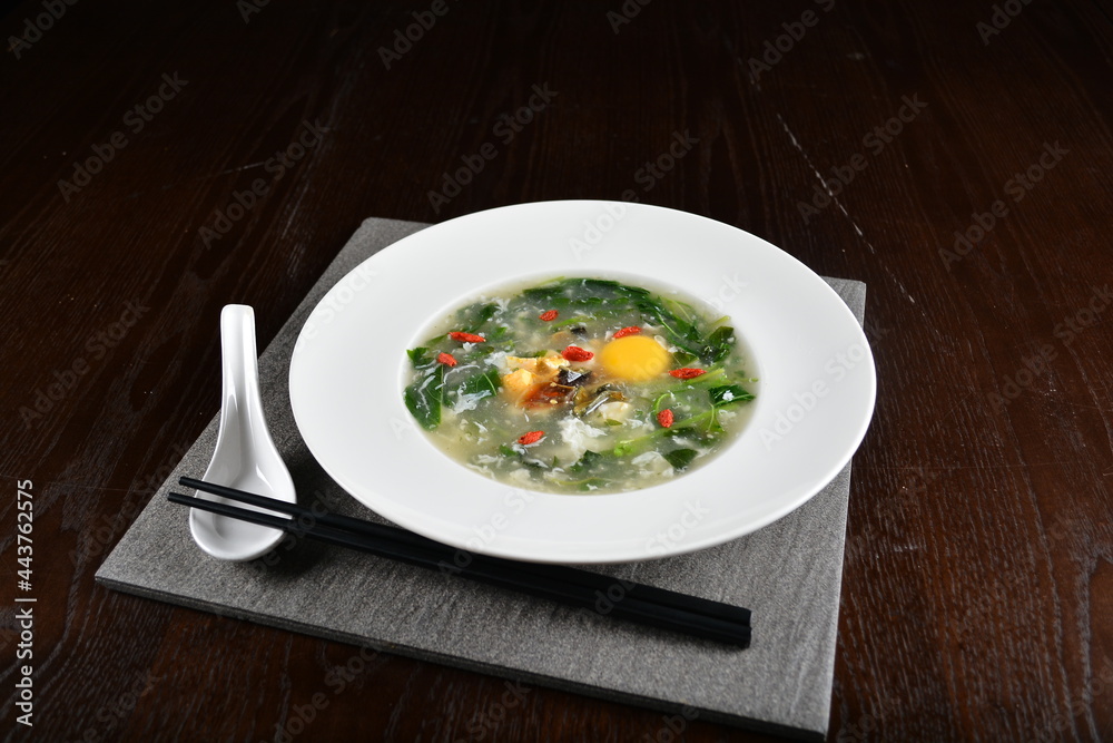 chinese wok fried water spinach vegetable with trio eggs century egg, salted egg, chicken egg and soup in dark background asian halal menu