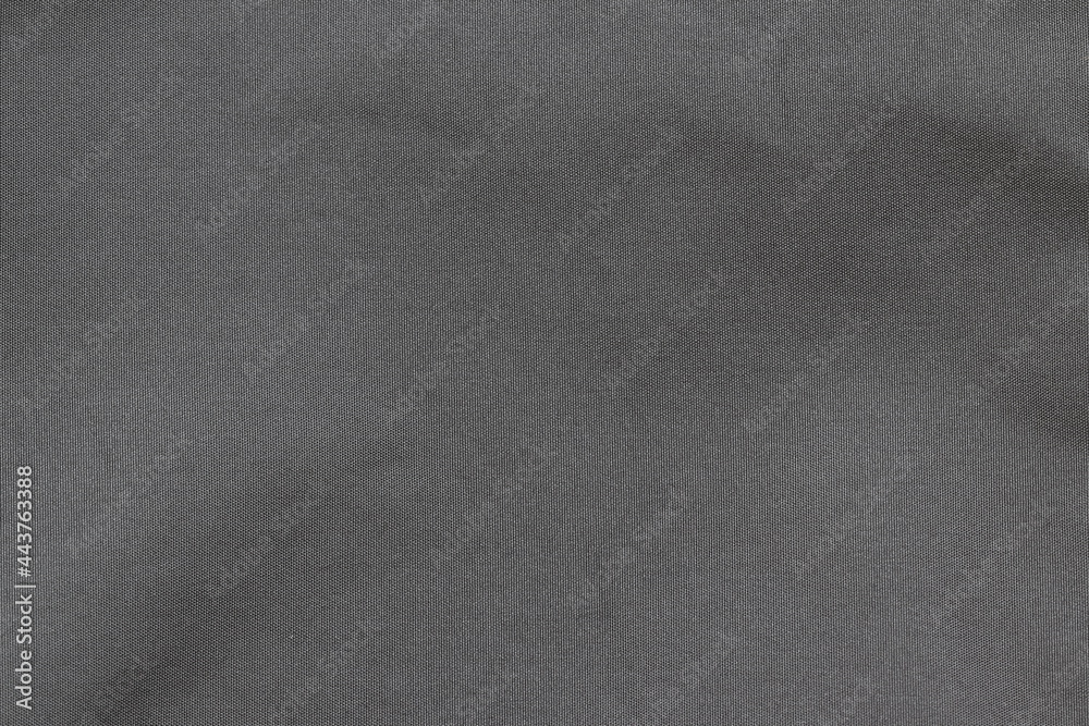 The texture of the black fabric of a small bag. The texture of the black fabric of a small bag.