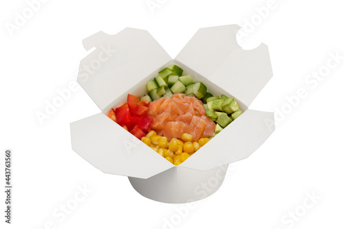 Salmon salad with vegetables in a white paper box. Ready food delivery, close-up, studio shot.