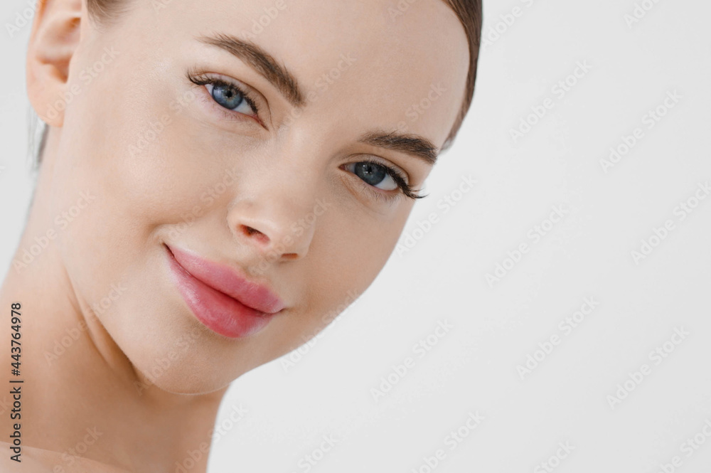 Beautiful woman face healthy skin natural make up lips close up blue eyes
