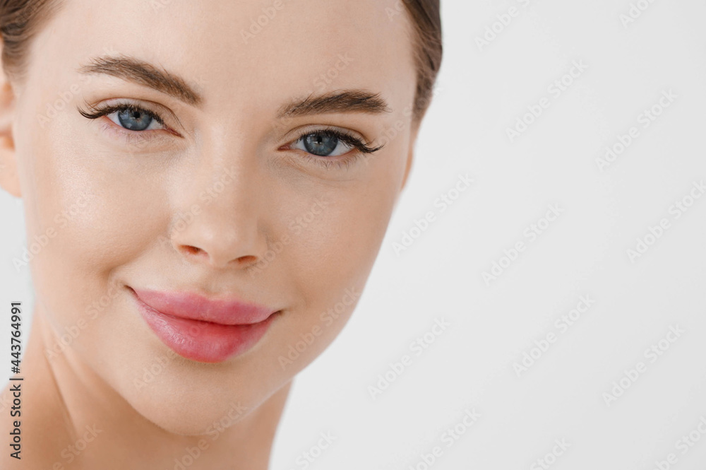 Beautiful woman face healthy skin natural make up lips close up blue eyes