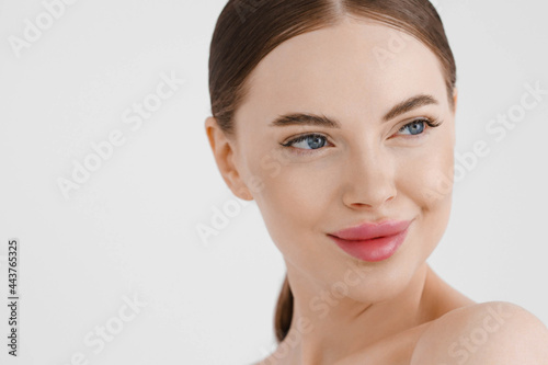 Beautiful woman face healthy skin natural make up lips close up blue eyes
