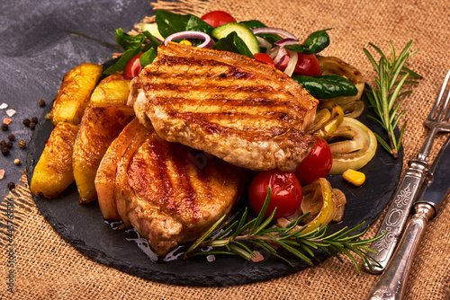 Fried juicy pork steak with vegetables.