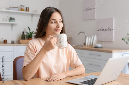 Young woman drinking tea in...