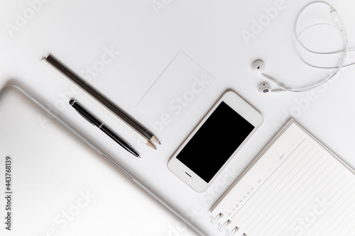 Office Accessories Top View.Laptop computer notebbok smartphone pencils and headphone isolated on white background.Working Device objects for freelance working concept.