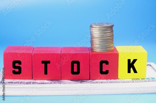 colored cubes, coins, banknotes and stock words. business concept
