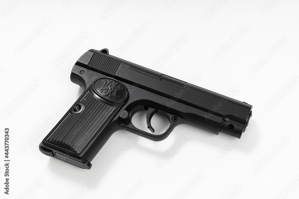 toy black gun on a white background. dangerous toys.