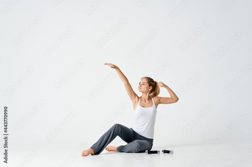sportive woman sitting on floor with dumbbells workout muscles sportive woman sitting on floor with dumbbells workout muscles