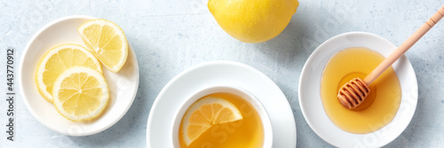 Lemon tea with honey overhead panoramic flat lay shot. Healthy organic citrus detox