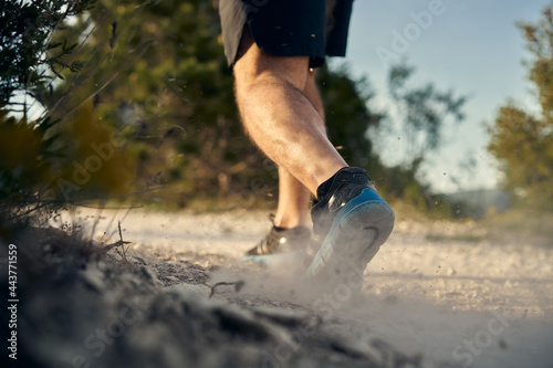 Close up of male muscular legs running up the hill