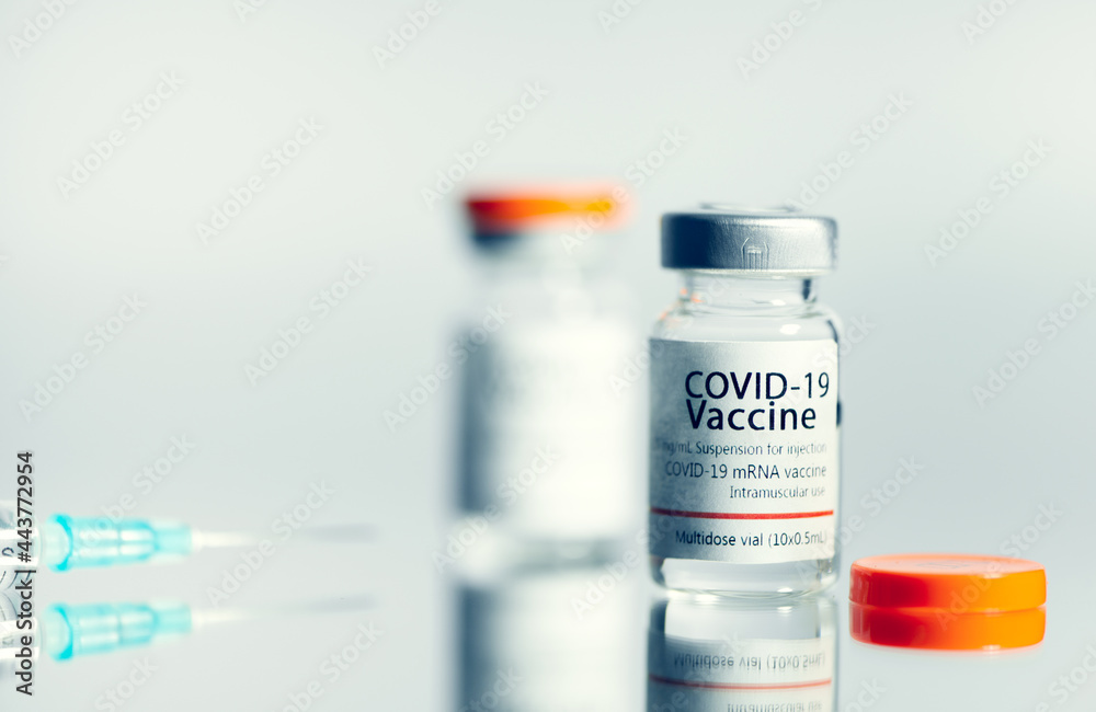 Ampoules with COVID-19 coronavirus vaccine, with a syringe for vaccination. Healthcare And Medical concept. Ampoules with COVID-19 coronavirus vaccine, with a syringe for vaccination. Healthcare And Medical concept.