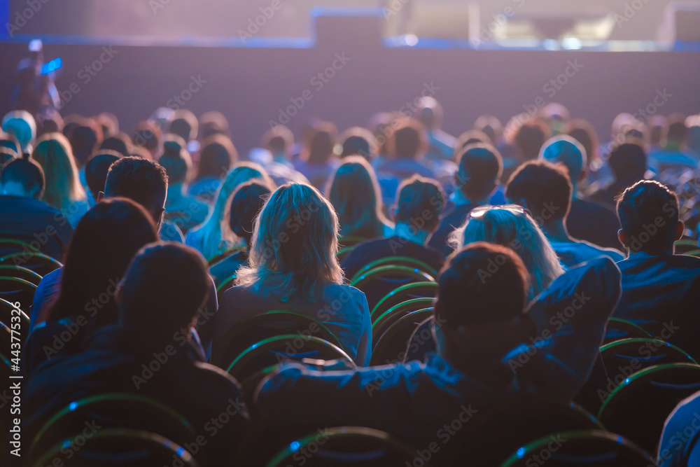 Obraz premium Unrecognizable people sitting in dark auditorium