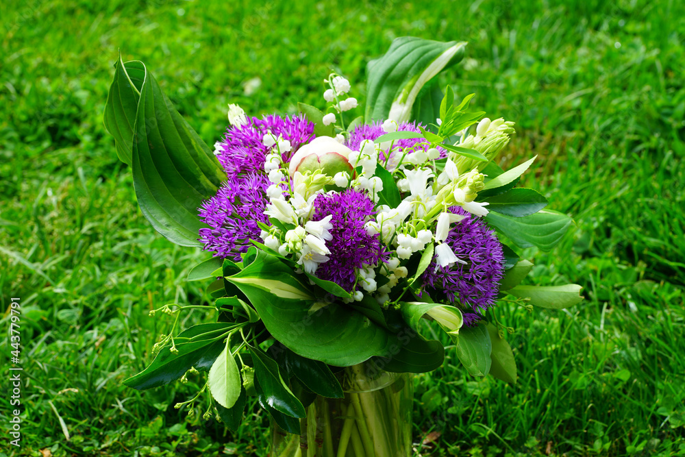 White and purple spring floral arrangement with alliums, lily of the valley and peony flowers White and purple spring floral arrangement with alliums, lily of the valley and peony flowers