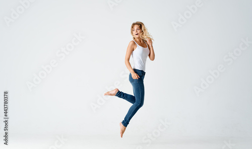cheerful blonde in a white tank top dance movement energy