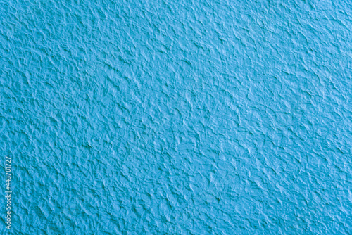 Plastered textured surface painted in blue - beautiful blue background