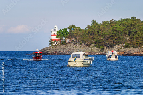 Boats at Luro lighthouse in lake Vanern, Sweden photo