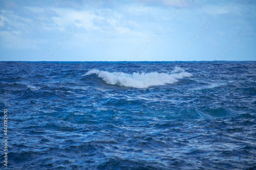 Summer sea background. Texture of water surface. Shining blue water ripple pattern.