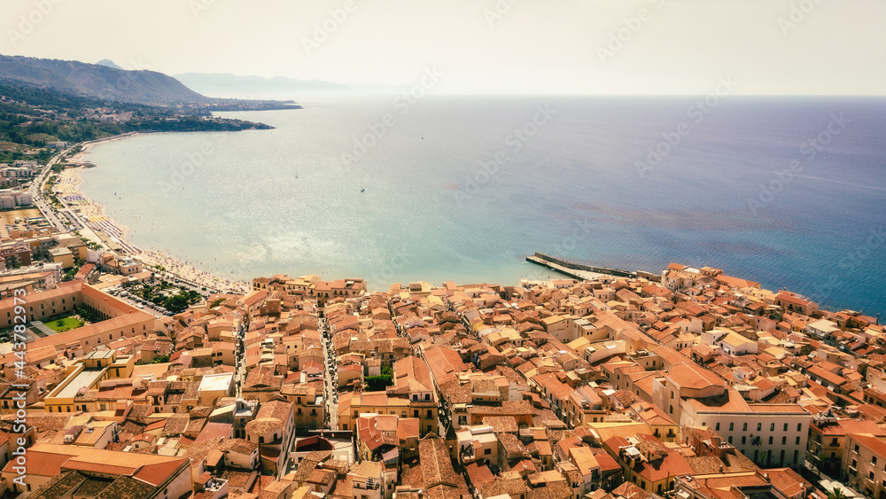 Naklejka premium City of Cefalù on Sicily in Italy, Europe on a warm summer evening. Coastal Town with Mountain