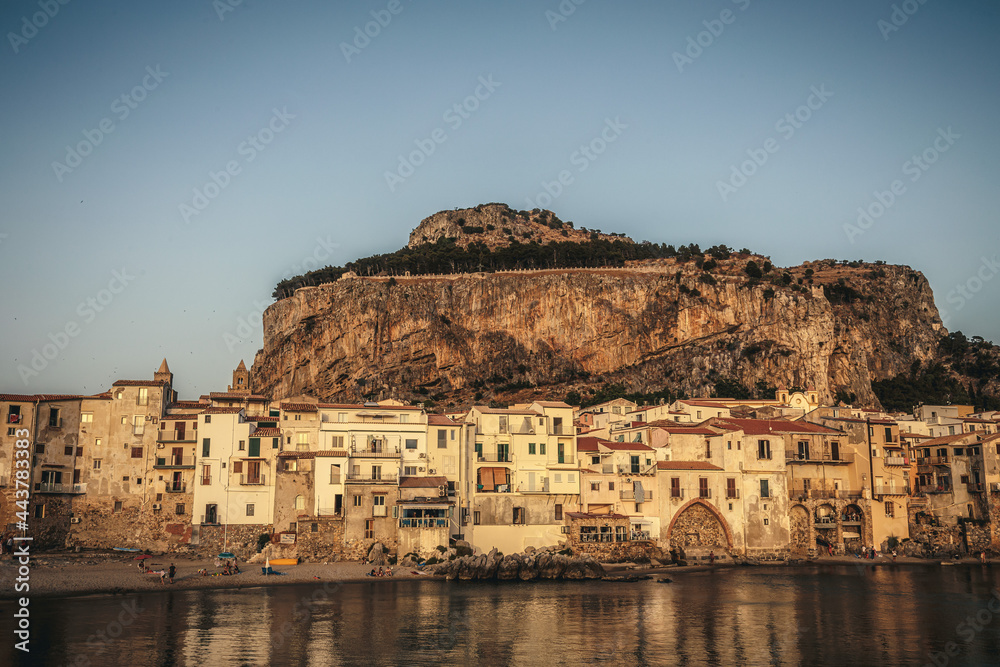 City of Cefalù on Sicily in Italy, Europe on a warm summer evening. Coastal Town with Mountain