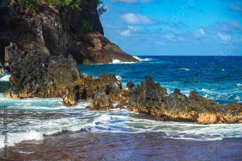 Sea shore with stones, ocean seascape. Sea waves over rocks on wild stone beach. Tropical sea relax.