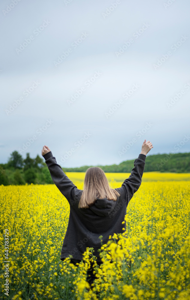 Young girl on yellow rapeseed field Young girl on yellow rapeseed field