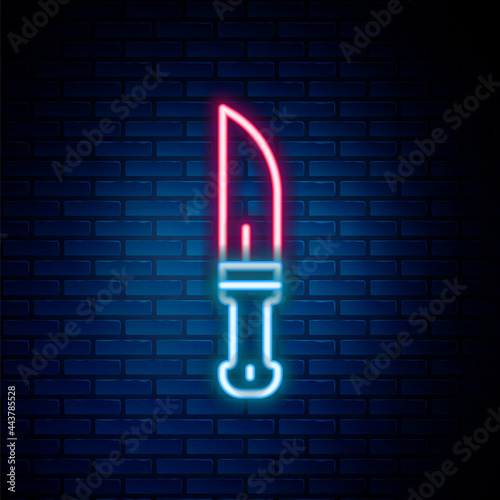 Glowing neon line Hunter knife icon isolated on brick wall background. Army knife. Colorful outline concept. Vector