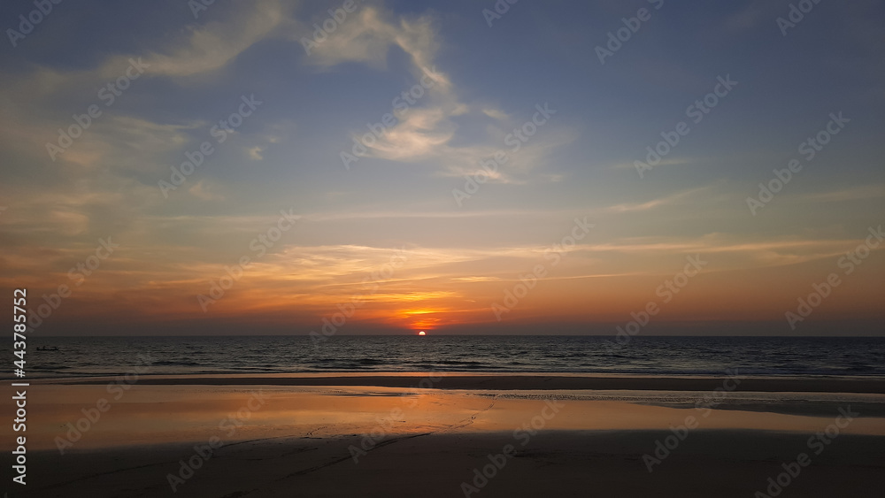 Silhouette of beautiful sunset on the Goa beach and travel in holiday relax time as summer, sunset in the tropical ocean. sunset in goa beach.