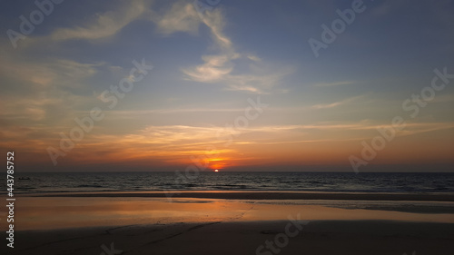 Silhouette of beautiful sunset on the Goa beach and travel in holiday relax time as summer  sunset in the tropical ocean. sunset in goa beach.