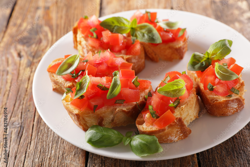 plate of bruschettas with tomato and basil plate of bruschettas with tomato and basil