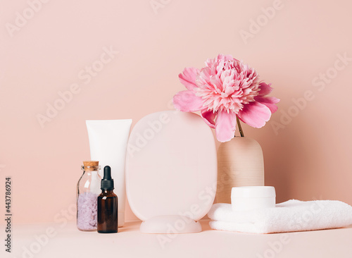 Women s accessories mirror cream oil various cosmetics on a table with flowers. Body and face care health beauty concept