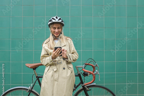 Woman in helmet using her smartphone device. Female 