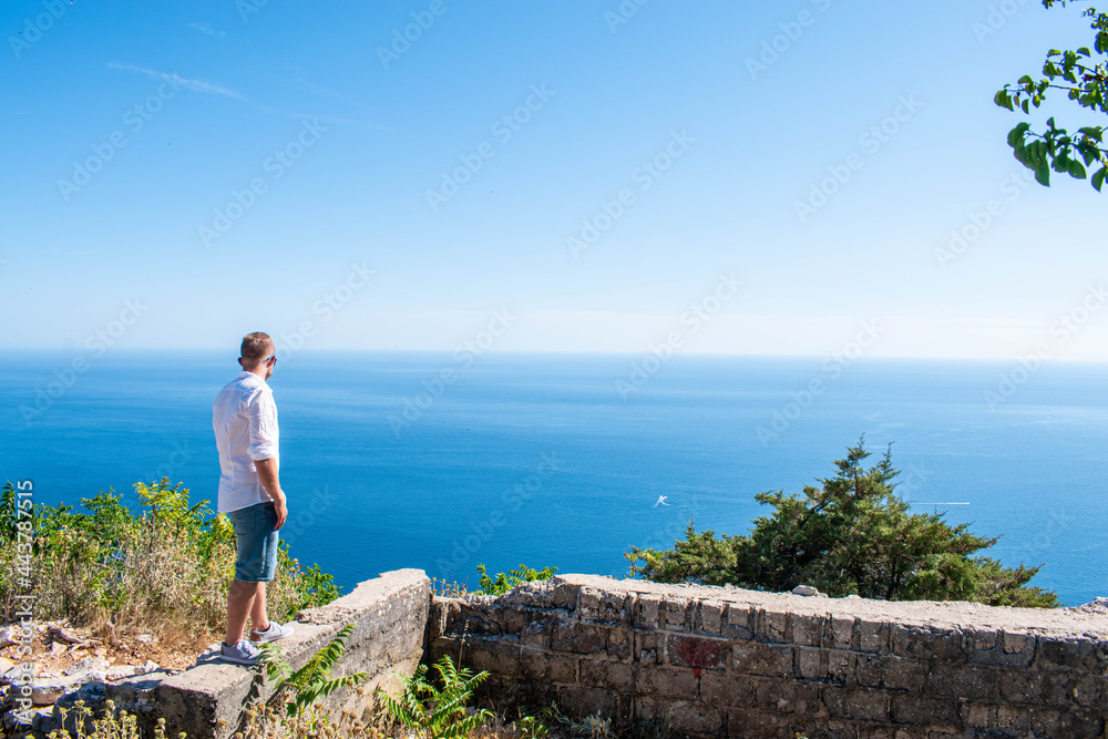 Man looking to sea. Travel and tourism concept