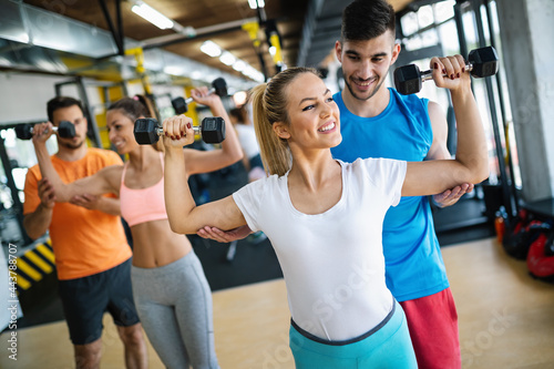 Group of fit young people exercising at the gym