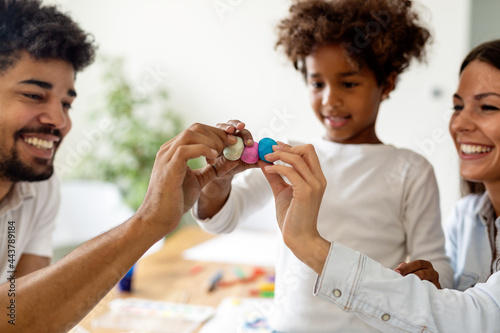 Happy multiethnic family spending time together at home. Parent child education fun concept photo