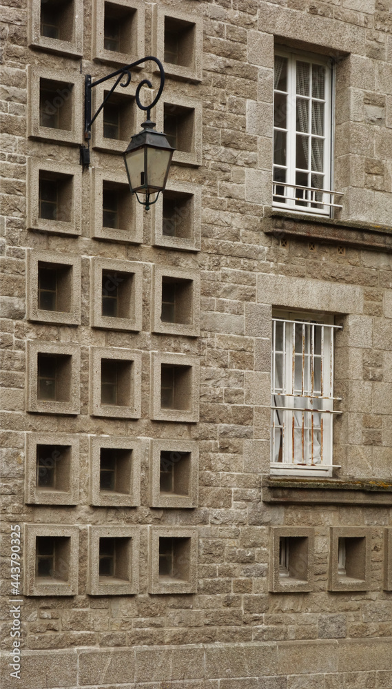 traditional wall street light on a stone wall, Saint Malo, France traditional wall street light on a stone wall, Saint Malo, France