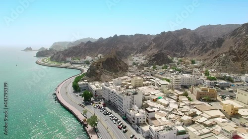 Muscat, Oman: Aerial view of capital city of sultanate on Arabian Peninsula, clear blue sky and emerald waters of Arabian Sea - landscape panorama of Middle East from above