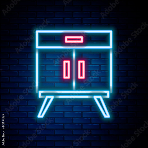 Glowing neon line Chest of drawers icon isolated on brick wall background. Colorful outline concept. Vector