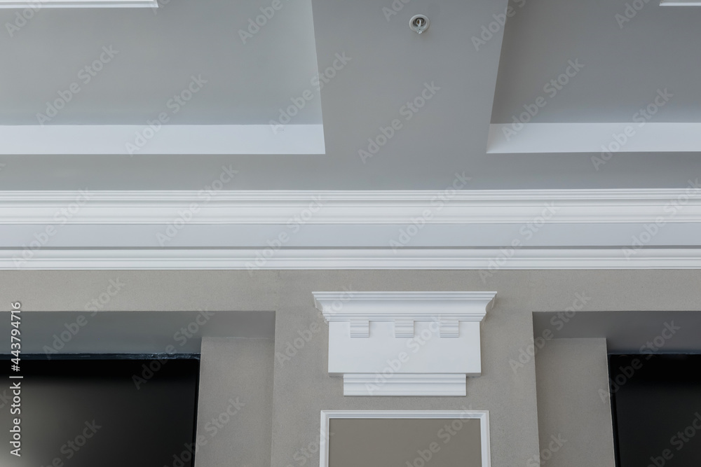 Detail of corner ceiling with intricate crown molding on column Detail of corner ceiling with intricate crown molding on column