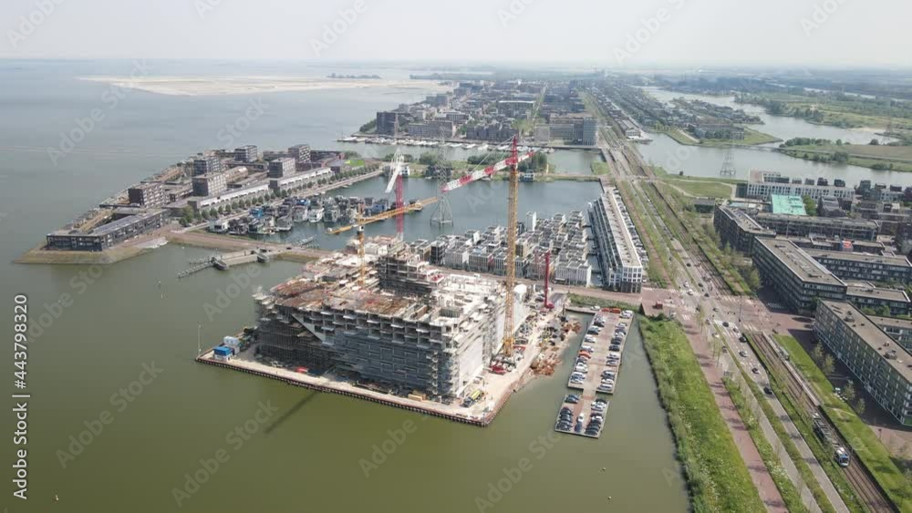 Construction site of the Sluishuis an appartment residential building with cranes near Ijburg, Amsterdam The Netherlands. Holland.