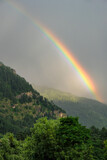 Views of the mountains in Manali with a rainbow in the background in Himachal Pradesh, India.