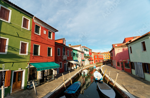 Venice landmark, Burano island canal, colorful houses and boats, Italy © zxvve