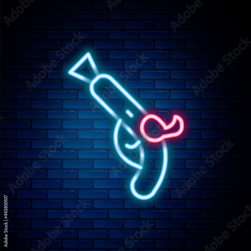 Glowing neon line Vintage pistols icon isolated on brick wall background. Ancient weapon. Colorful outline concept. Vector