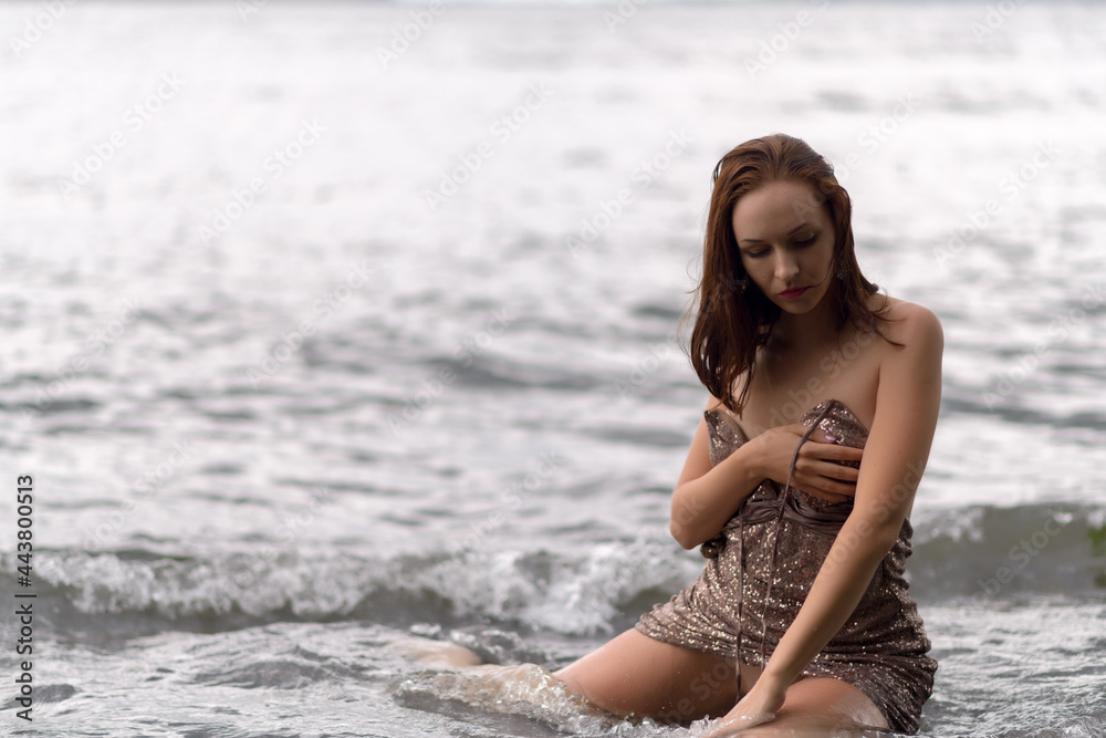 Beautiful woman in a dress on a beach. Beautiful woman in a dress on a beach.