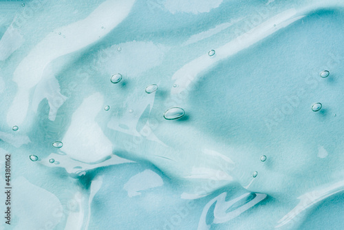 Transparent hyaluronic acid gel on a blue background. photo