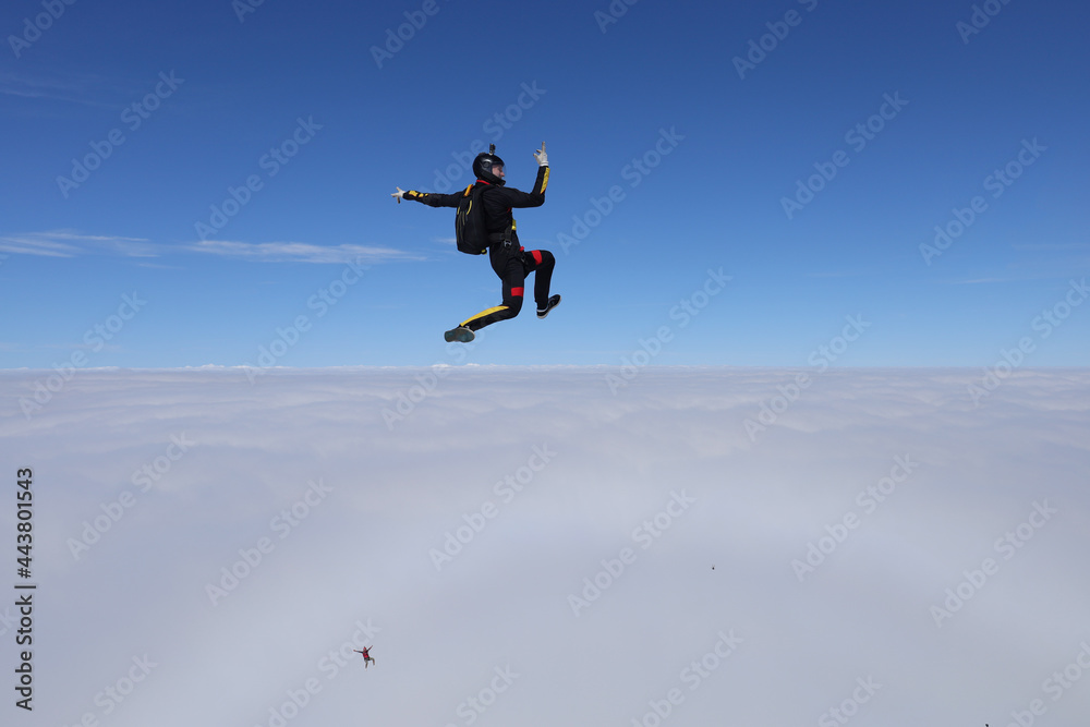 Skydiving. Freefly jump. Solo skydiver is above clouds.