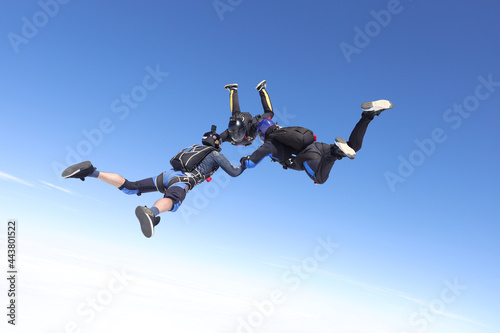 Skydiving. Three skydivers are falling together.