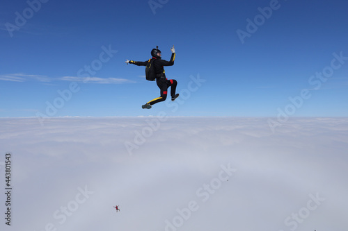 Skydiving. Freefly jump. Solo skydiver is above clouds.