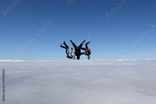 Skydiving. Three skydivers are falling headdown together.