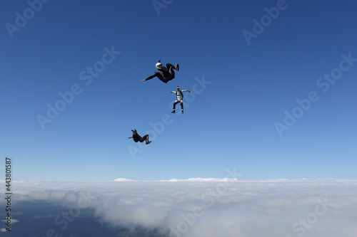 Skydiving. Three skydivers are having fun in the sky.